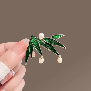 Chinese style green enamel bamboo leaf brooch with white pearls on a gold metal base