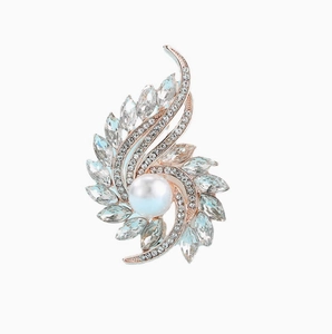 Detailed macro view of an elegant floral brooch with large pearl and crystals