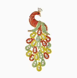 Detailed macro view of colorful rhinestones on a golden peacock brooch for women