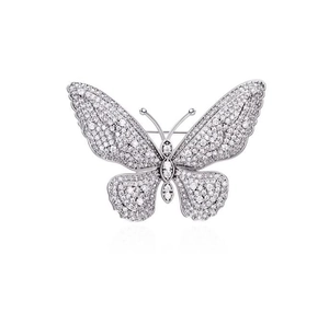 Macro detail of silver-tone butterfly brooch with pave-set cubic zirconia crystals