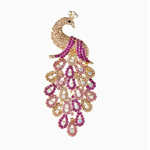 Detail of elegant peacock brooch with purple and pink crystals on gold plating