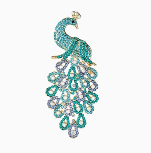 Detailed view of elegant peacock brooch with vibrant blue rhinestones on gold base