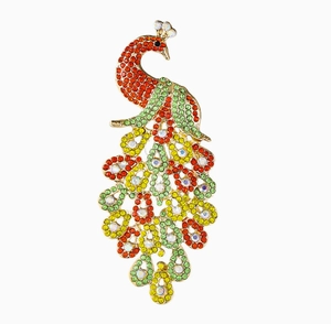 Detail of elegant peacock brooch with colorful crystals and gold metal setting