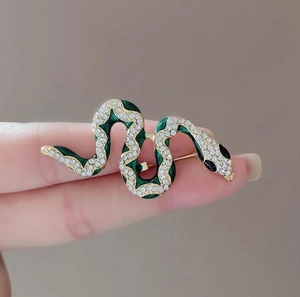 Elegant gold-plated snake brooch with green enamel and sparkling white crystals