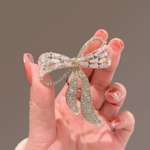 Elegant gold bow brooch with sparkling rhinestones for luxury suit and sweater styling