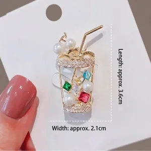 Glittery drink cup brooch with pearls and colorful gems on golden metal base