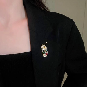 Sparkling crystal milk tea cup brooch with pearls pinned on a black suit lapel