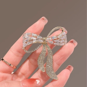 Elegant gold bow brooch with sparkling cubic zirconia crystals for women suits