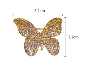 Detailed size view of the butterfly brooch measuring 3.2cm by 3.2cm with sparkling diamonds