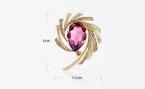 Detailed view of luxury crescent brooch with pink gemstone and rhinestones 6cm x 4.6cm