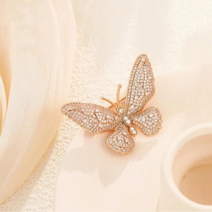 Vintage rose gold butterfly brooch with micro-pave cubic zirconia on a minimalist base