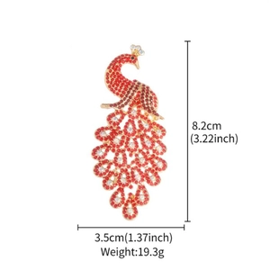 Exquisite gold peacock brooch set with sparkling red crystals and small white rhinestones