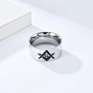 Primer plano de anillo masónico de acero inoxidable pulido con logo de escuadra y compás grabado