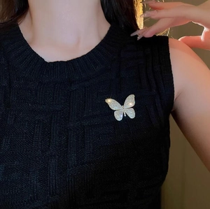 Sparkling butterfly brooch with silver crystals on black suit jacket, elegant woman accessory