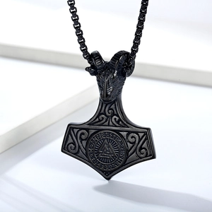 Detail of black Viking Mjölnir pendant with ram head, runes and Valknut symbol