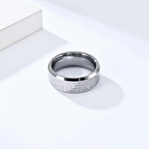 Macro shot of silver tungsten ring featuring laser-engraved cross and scripture details
