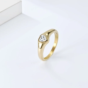 Detailed close-up of a gold-plated heart-shaped zircon ring on a white pedestal