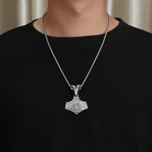 Nordic Viking Mjolnir pendant necklace with ram head and Valknut symbol on model