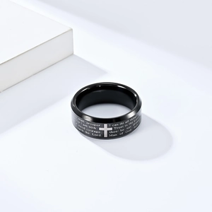 Detail shot of laser engraved bible verses and cross patterns on black tungsten ring