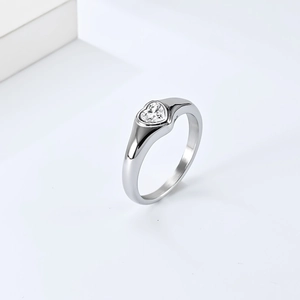 Macro view of heart-shaped diamond set in silver stainless steel ring band