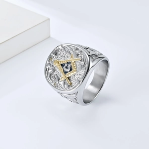 Close-up of vintage steel ring featuring golden Freemason symbol and detailed embossing