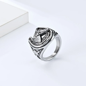 Detail view of retro steel ring featuring horse head and Masonic symbol carvings