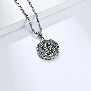 Macro shot of silver Bitcoin coin pendant with 3D embossed logo and circuit texture details