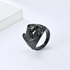 Detail of vintage matte black stainless steel ring featuring an intricate hollow horse head