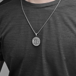 Men's silver Bitcoin coin pendant necklace with 18K gold plated box chain on grey shirt