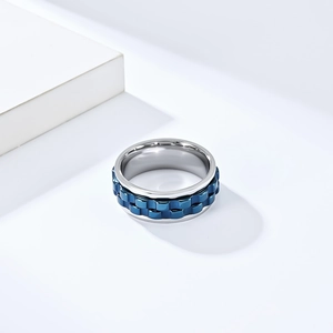 Detail of blue gear-shaped spinning inner band on a silver stainless steel fidget ring