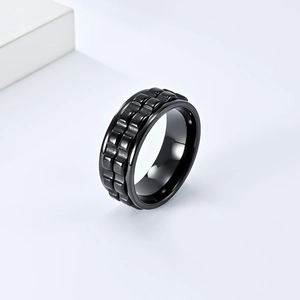 Close-up of black rotatable gear spinner ring with industrial tire texture finish