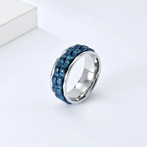 Rotating stainless steel gear ring with blue mechanical texture on silver finish