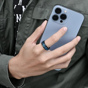 Close-up of rotating gear stress relief ring in black titanium steel with blue inlay