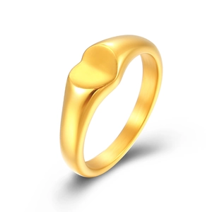 Minimalist gold heart signet ring with polished finish shown from a side angle