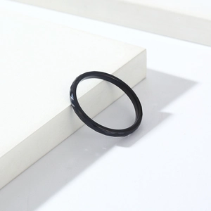 Detailansicht eines schwarzen Wolframrings mit geometrischem Diamantschliff auf Podest
