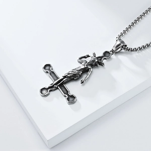 Macro detail of gothic Baphomet goat head relief on an inverted cross pendant