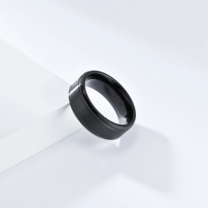 Bague minimaliste en acier titane noir mat brossé pour hommes et femmes sur support blanc