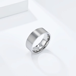 Macro detail of industrial style silver stainless steel ring with textured band surface