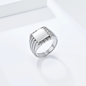 Detailed macro view of silver square signet ring with vertical side textures and metal finish