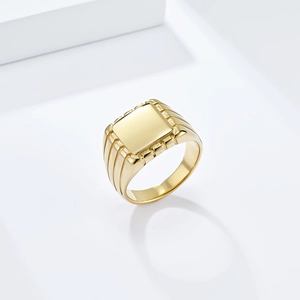 Polished gold square signet ring in minimalist stainless steel displayed on white blocks