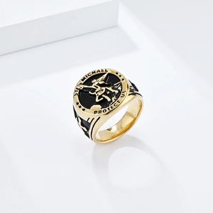 Macro detail of gold St. Michael Archangel signet ring with black enamel and shield icons