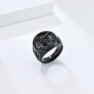 Close-up of Saint Michael Archangel prayer engraving on matte black stainless steel ring