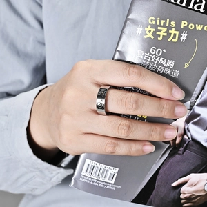 Detailed close-up of a wide silver ring with animal totem etching on a model hand