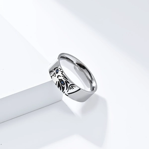 Macro detail of silver titanium steel tiger ring with blue zircon eyes and engraving