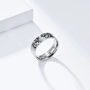 Minimalist titanium steel tiger head ring with black engraved details on white background