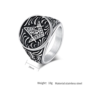 Macro shot of stainless steel Freemason ring showing intricate side carvings and gemstone detail