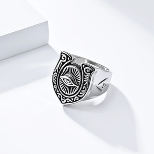Macro shot of retro stainless steel horseshoe ring featuring detailed evil eye engraving