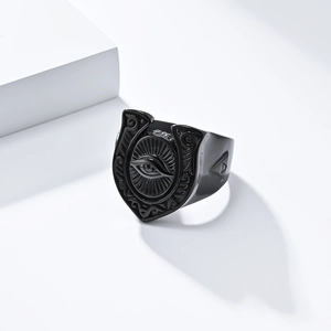 Macro shot of retro black horseshoe ring featuring a detailed all-seeing eye engraving