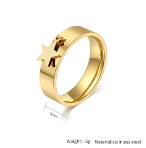 Detail view of 6mm gold stainless steel ring with a small star pendant charm