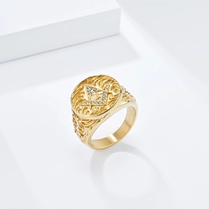 Close-up of gold Masonic ring with compass square symbol and engraved floral details